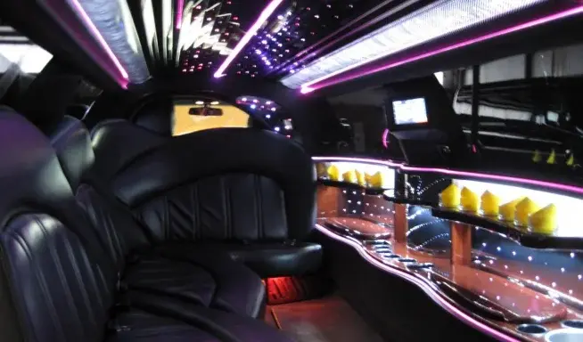 Traditional stretch limousine interior with leather seating and ambient lighting