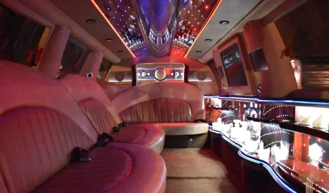 Stretch SUV limousine interior with wraparound seating and ambient lighting